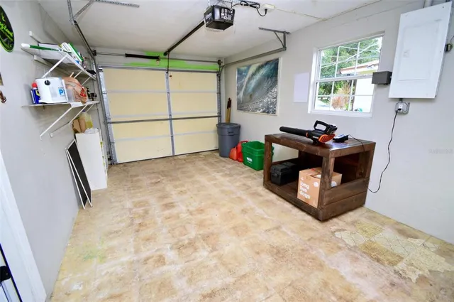 a large kitchen with a stove a refrigerator a sink a microwave and a dining table