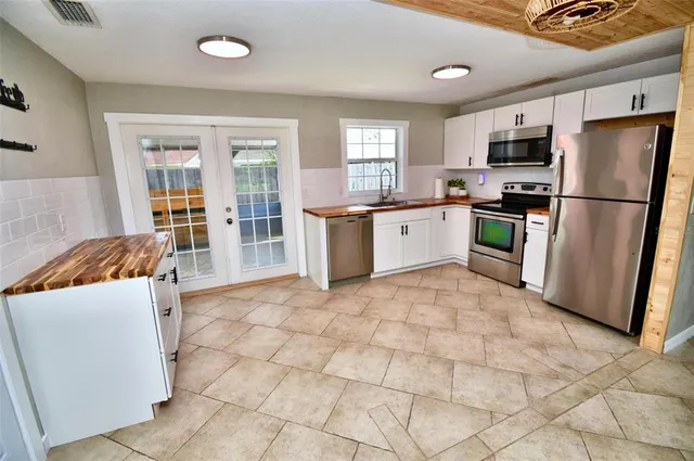 a kitchen with stainless steel appliances a stove sink and refrigerator
