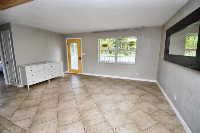 a spacious bedroom with a bed and window
