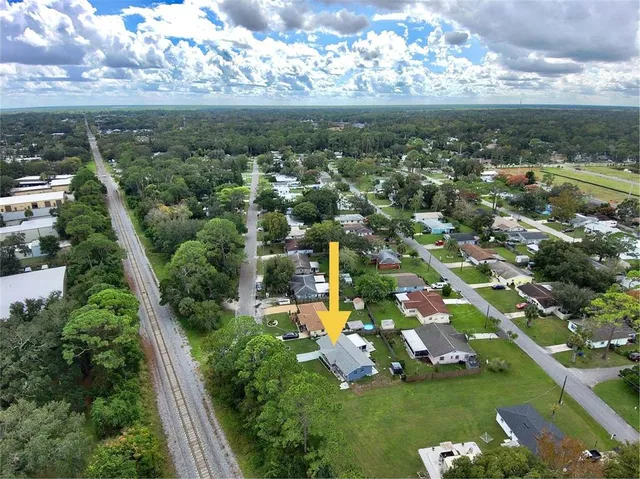 an aerial view of a house with garden space and street view