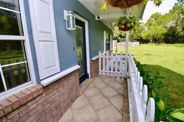 a view of a backyard with sitting area