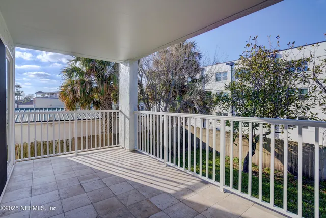 a view of a porch with a floor to ceiling window and stairs