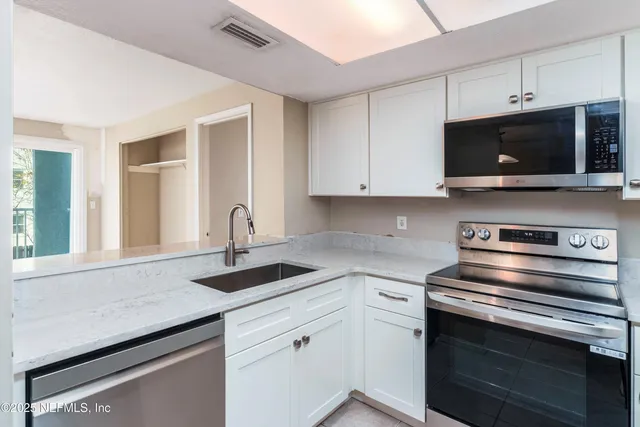 a kitchen with a sink stove and microwave