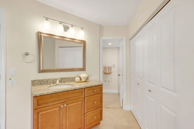a bathroom with a granite countertop sink mirror and double