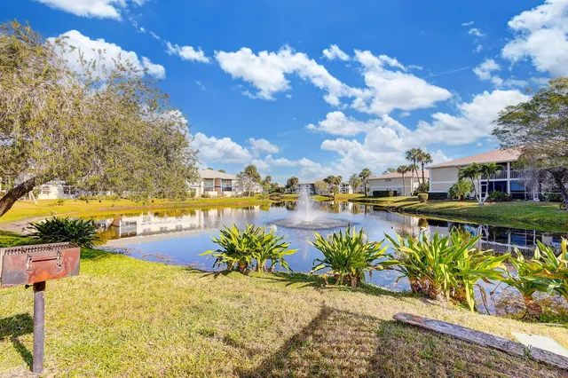 a view of a lake with a table and chairs