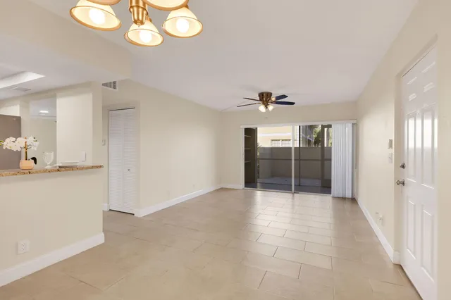 an empty room with cabinet and windows