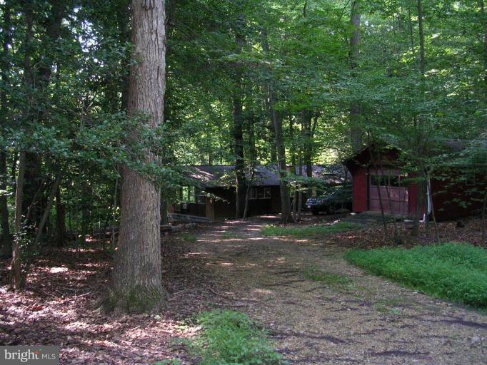 2704 Hidden Valley Road Accokeek, MD 20607 - Photo 7 of 15 a backyard of a house with lots of green space and fountain