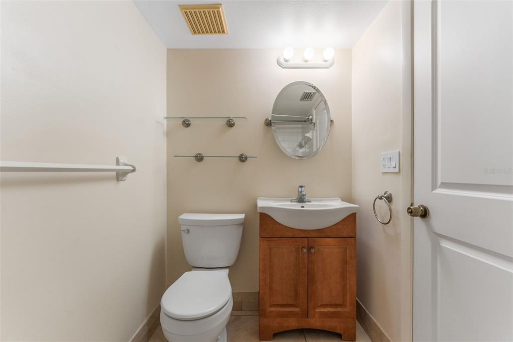 219 Cypress Court, Unit 219 Oldsmar, FL 34677 - Photo 25 of 34 a bathroom with a toilet a sink and a mirror