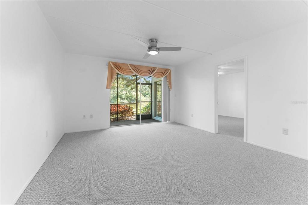 219 Cypress Court, Unit 219 Oldsmar, FL 34677 - Photo 10 of 34 an empty room with windows and ceiling fan