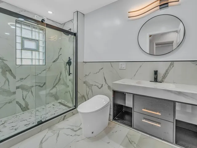 a bathroom with a sink toilet and shower