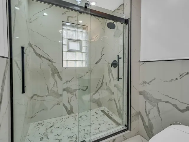a bathroom with a shower and toilet