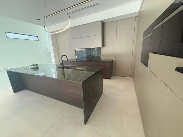 a bathroom with a granite countertop sink a toilet and a mirror