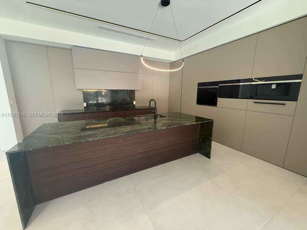 135 Southwest 29th Road Miami, FL 33129 - Photo 16 of 69 a living room with stainless steel appliances kitchen island granite countertop furniture and a fireplace