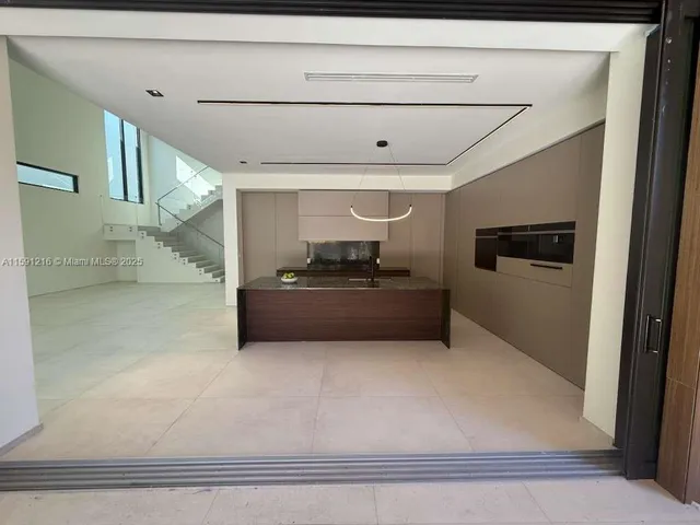 a view of an empty room with glass door and a window