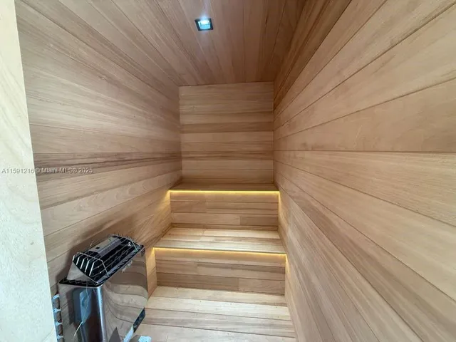 a white bath tub sitting in a bathroom next to a window