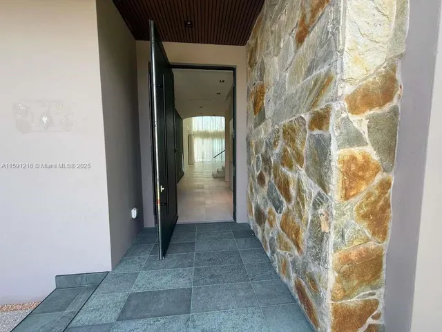 a living room with furniture a window and a potted plant