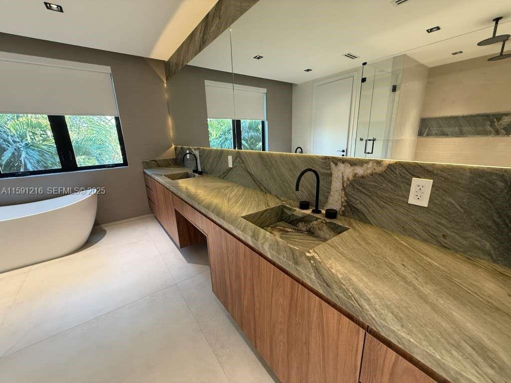 135 Southwest 29th Road Miami, FL 33129 - Photo 44 of 69 a large kitchen with kitchen island granite countertop a sink and a stove