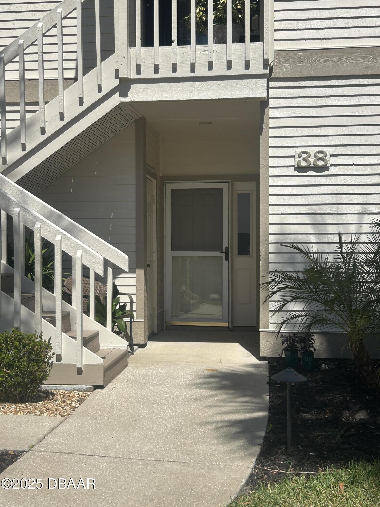 38 Magnolia Drive South, Unit S Ormond Beach, FL 32174 - Photo 1 of 12 a front view of a house with a garden