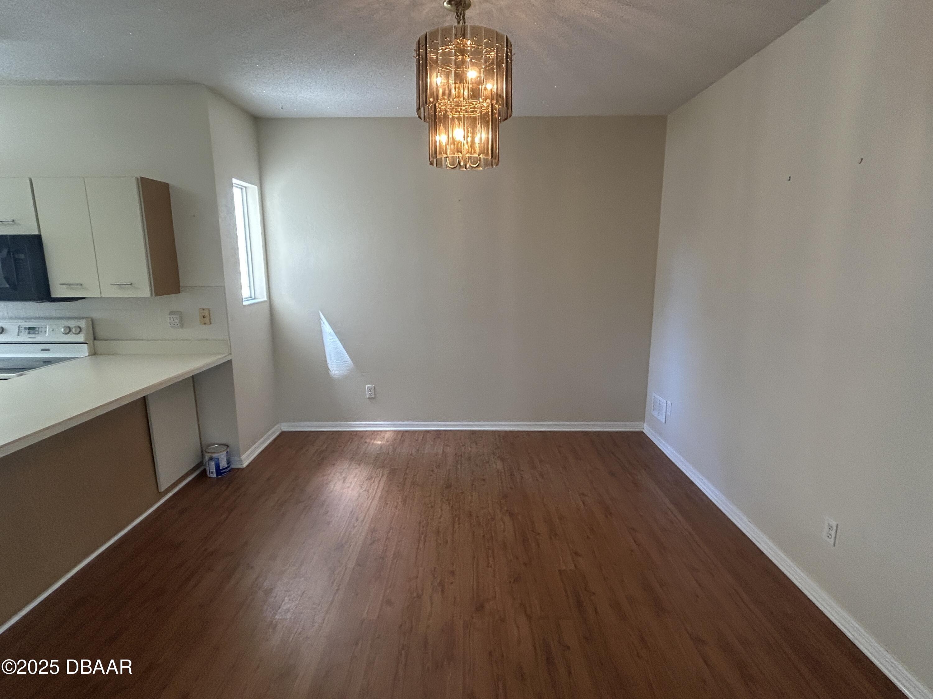 38 Magnolia Drive South, Unit S Ormond Beach, FL 32174 - Photo 4 of 12 a room with wooden floor and window