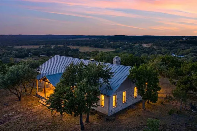 a view of a terrace with a yard and wooden fence