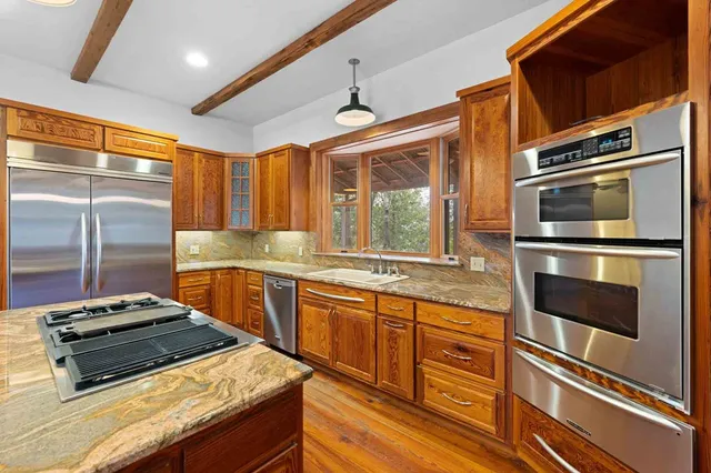a view of an empty room window and wooden floor