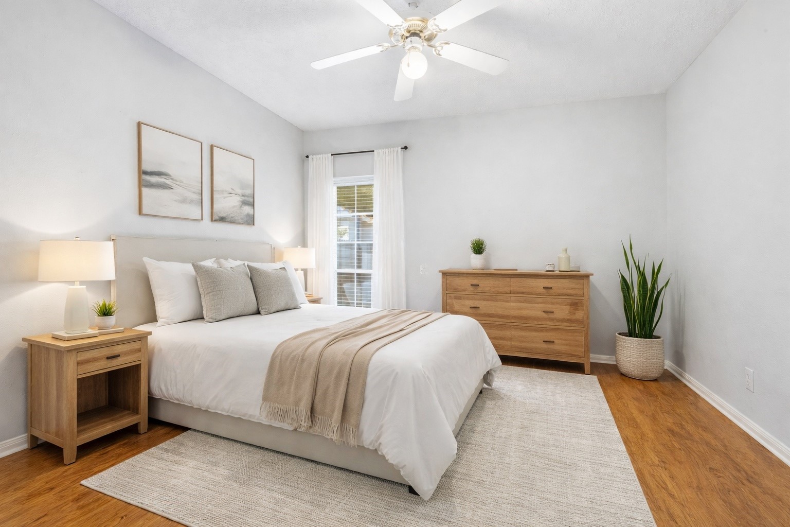 21719 Long Castle Drive Spring, TX 77388 - Photo 11 of 19 This bedroom features a white modern ceiling fan, wood flooring and a large window, providing a bright and comfortable living space.*virtually staged