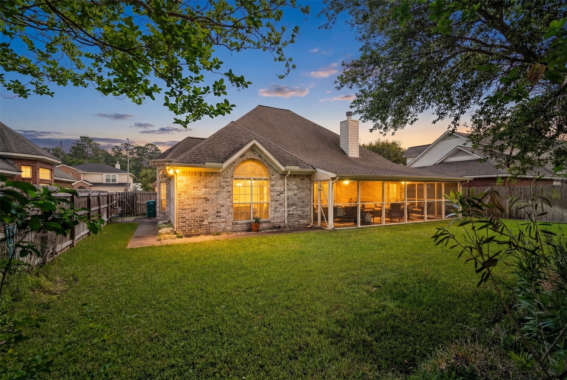 21719 Long Castle Drive Spring, TX 77388 - Photo 15 of 19 Enjoy this fenced-in backyard with a well-maintained lawn and a covered patio, perfect for relaxing in the sun, or creating your own garden oasis.