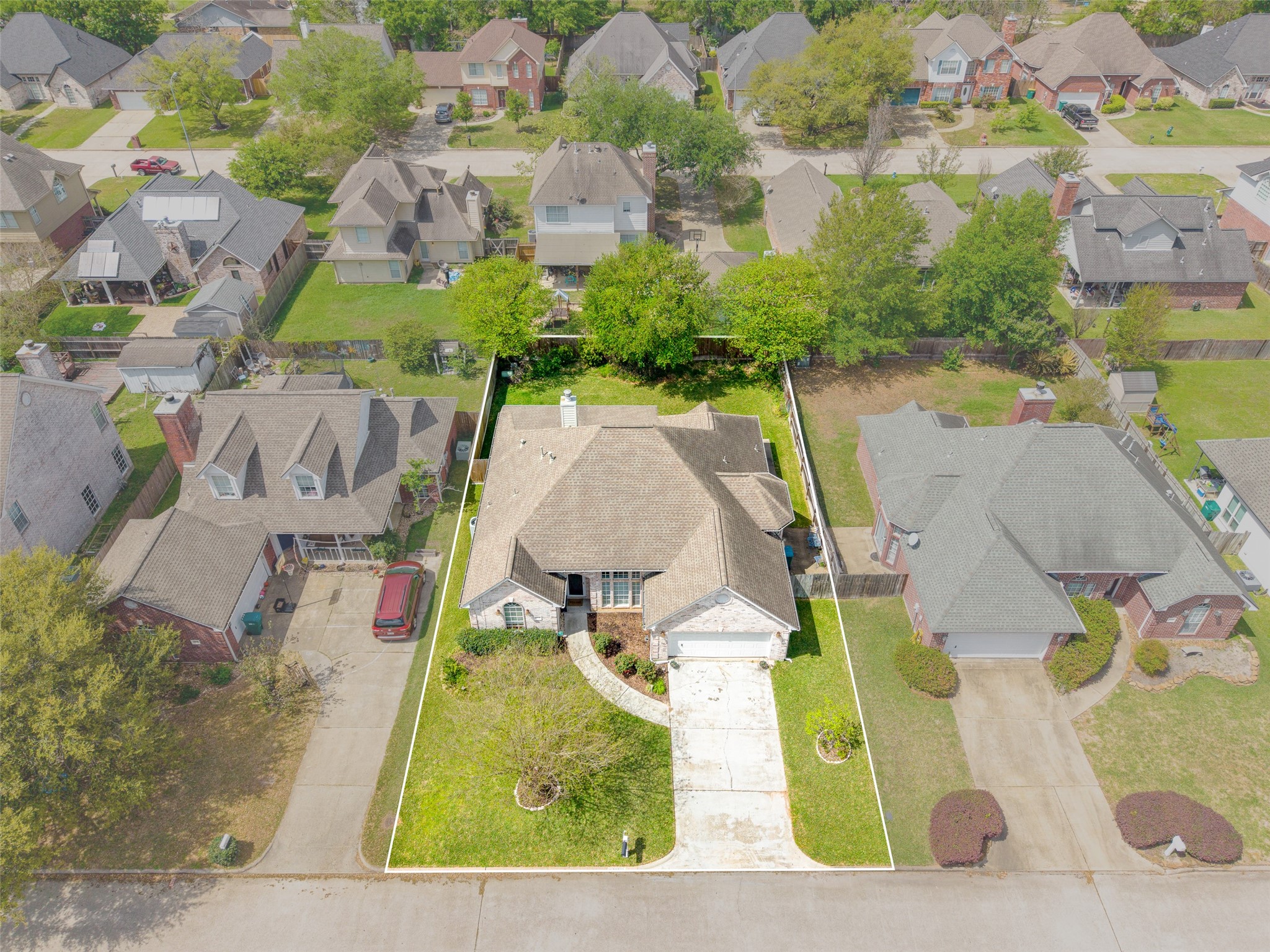 21719 Long Castle Drive Spring, TX 77388 - Photo 16 of 19 This stunning aerial view highlights the front of the home, showcasing its beautiful architecture, curb appeal, and inviting presence within the neighborhood.