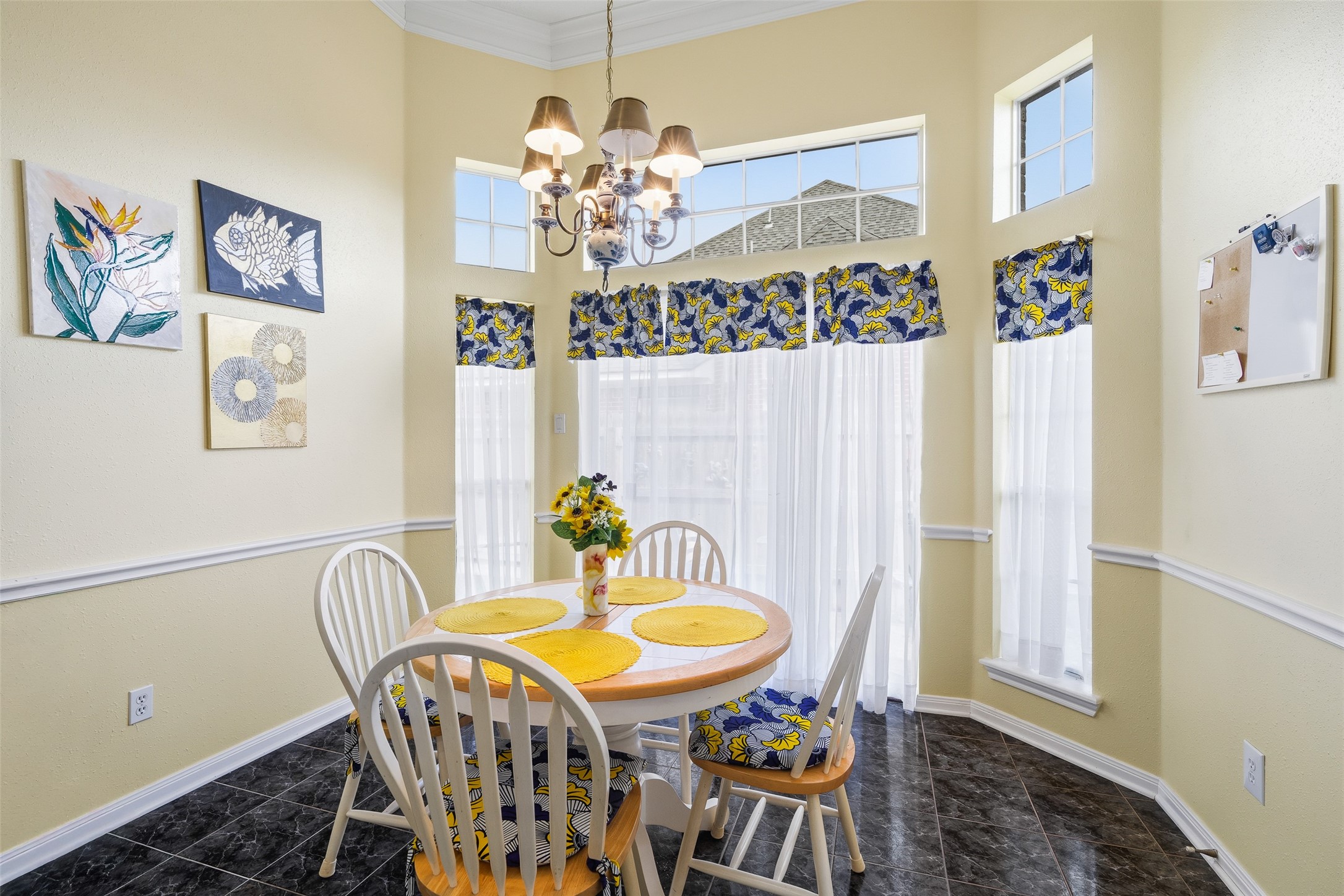 21719 Long Castle Drive Spring, TX 77388 - Photo 7 of 19 The charming breakfast area features a stylish chandelier, durable tile flooring, and a multiple windows—making mealtime both elegant and effortless.
