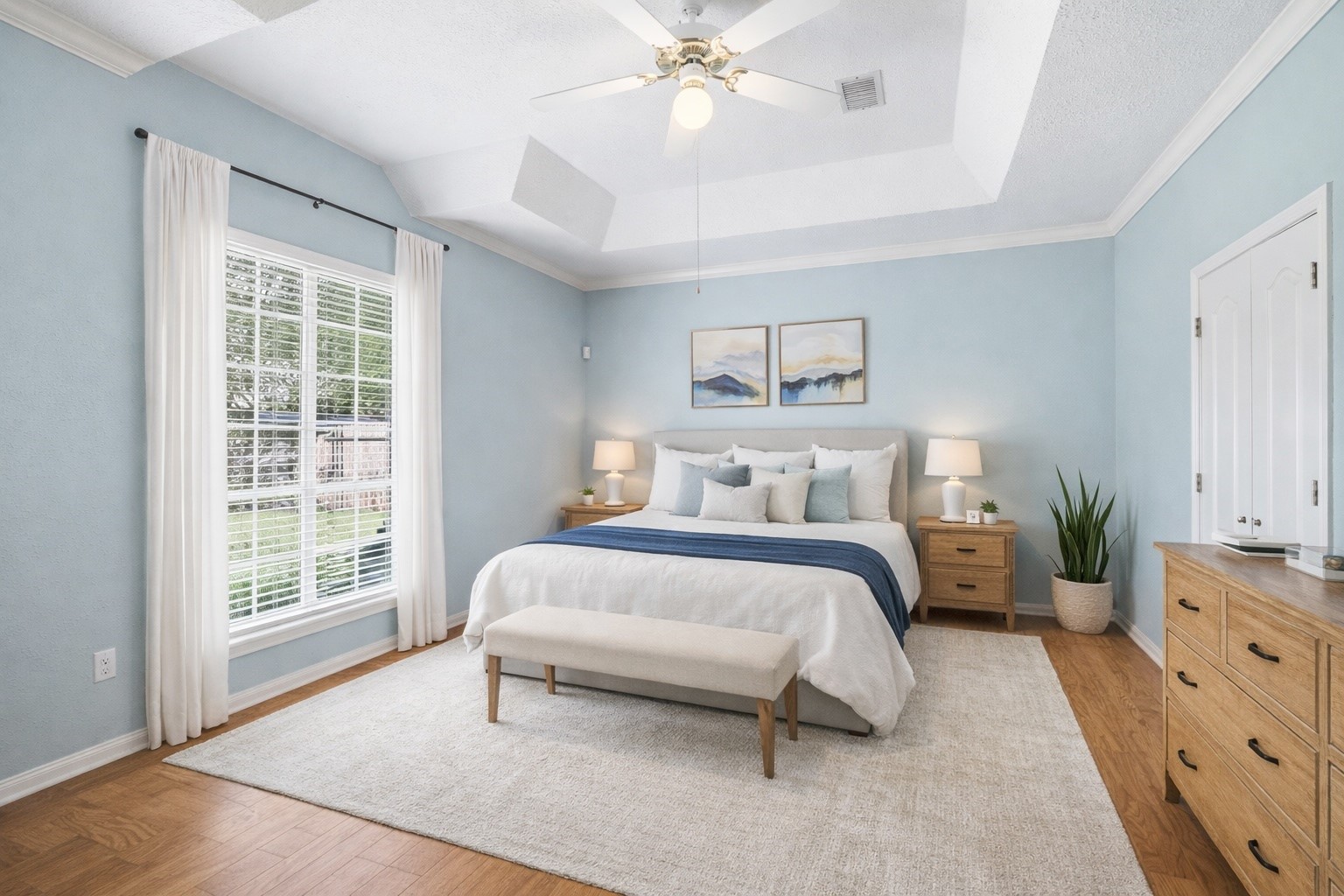 21719 Long Castle Drive Spring, TX 77388 - Photo 8 of 19 The primary bedroom offers wood flooring, a unique ceiling design, a large window that fill the room with natural light, and a ceiling fan for added comfort — a perfect private retreat.*virtually staged