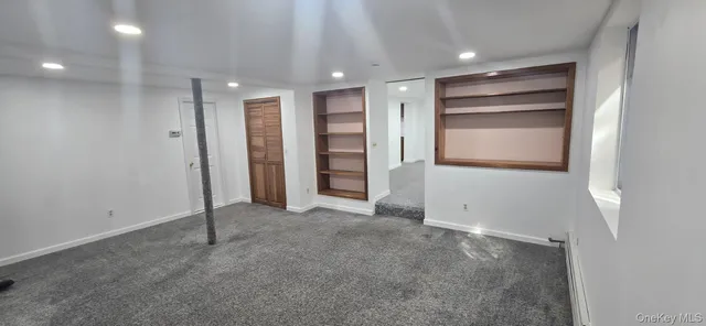 a view of an empty room with a closet