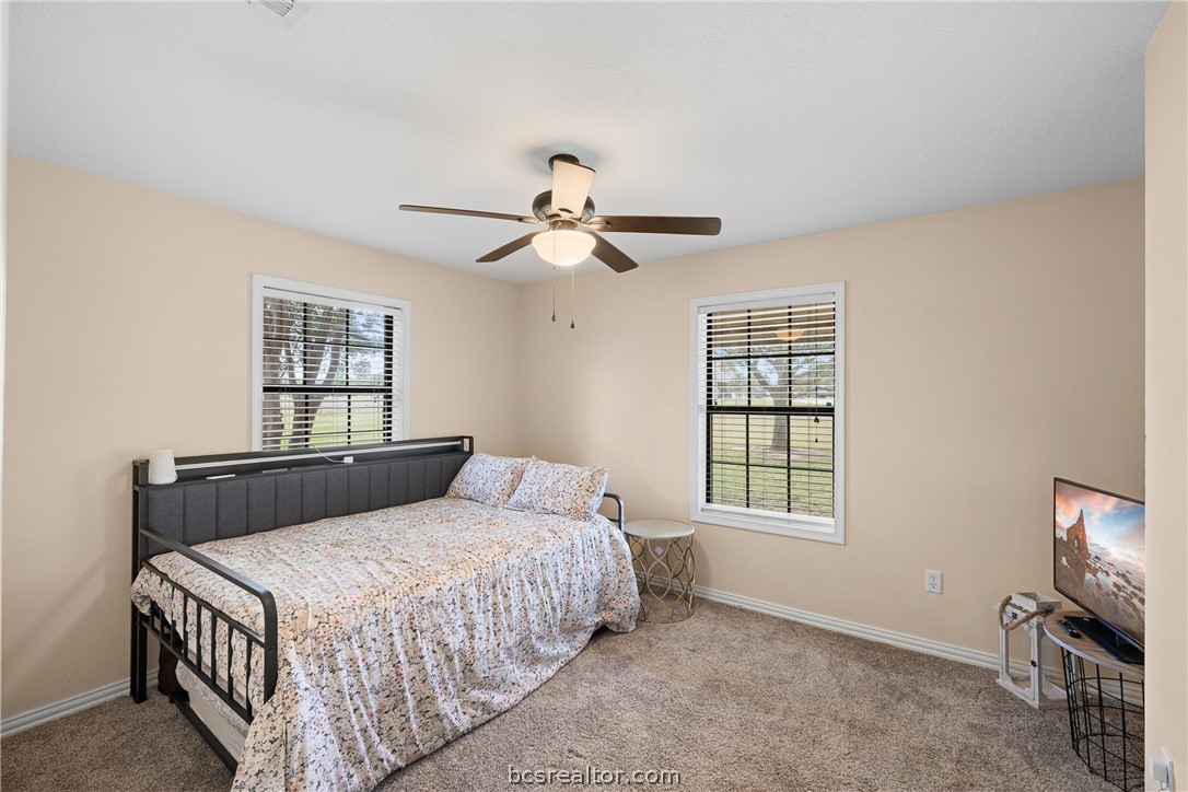 3540 Fisher Ranch Road Bryan, TX 77808 - Photo 15 of 36 a bedroom with a bed chandelier and a window