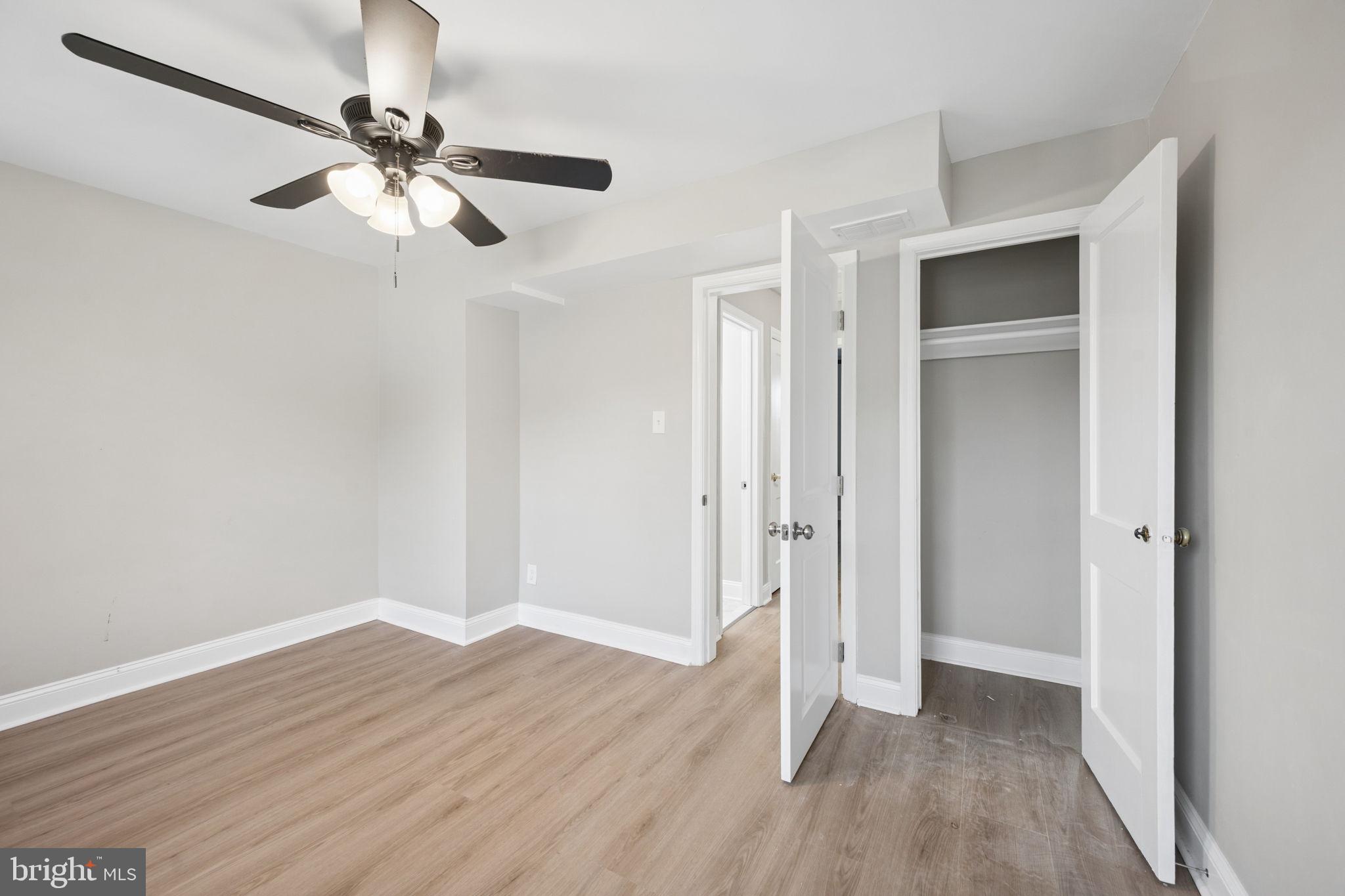 3548 Benzinger Road Baltimore, MD 21229 - Photo 16 of 40 an empty room with wooden floor closet and fan