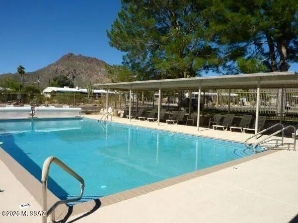 a view of a swimming pool with a garden and seating area