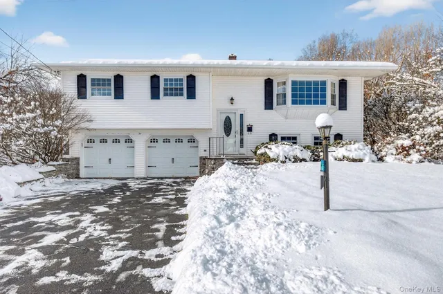 a view of a house with a yard covered in snow