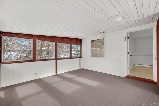 a view of a room with wooden floor and a ceiling fan