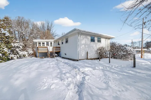 a view of a house with a snow in front of it