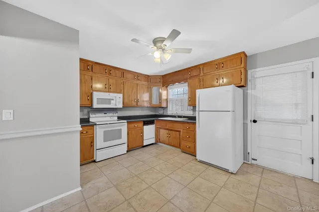 a kitchen with stainless steel appliances a refrigerator sink and stove