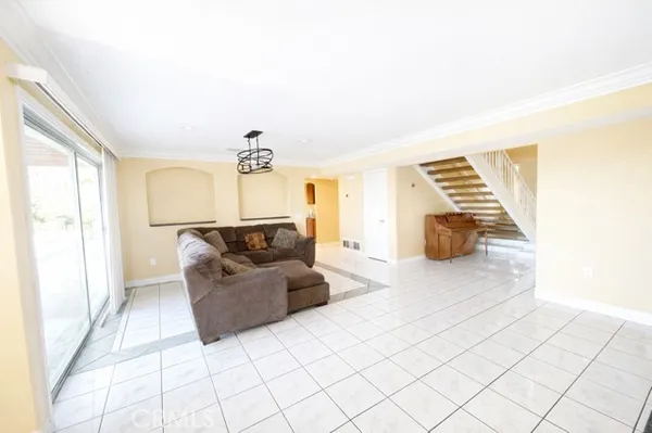a living room with furniture and a chandelier