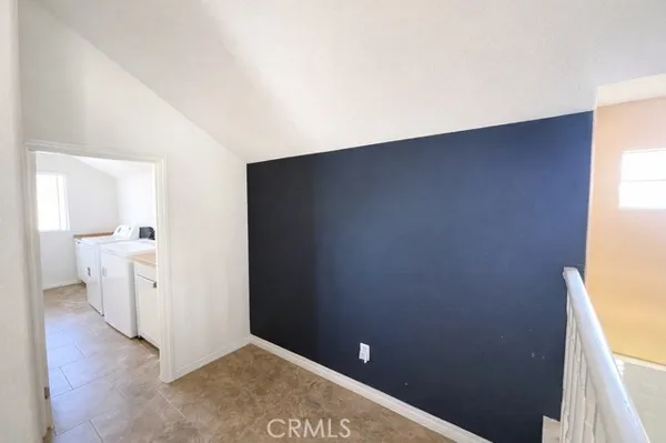 a view of a room with white cabinets and sink