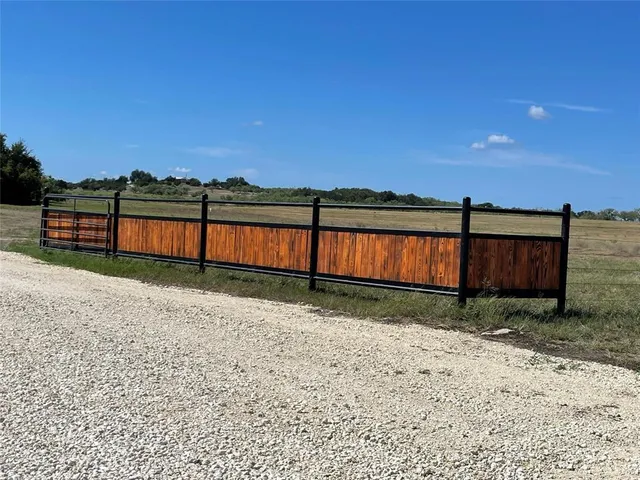a view of a backyard with large trees