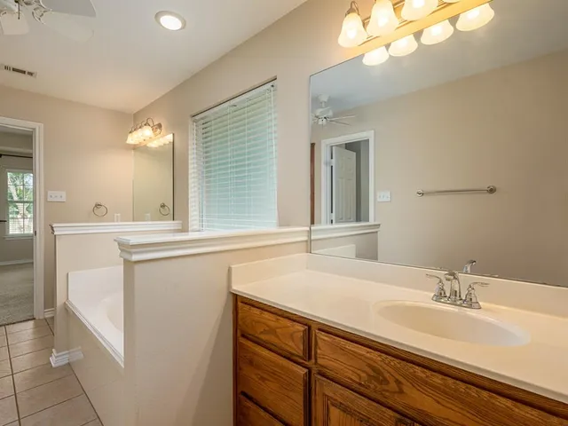 a bathroom with a sink a mirror and a light fixture