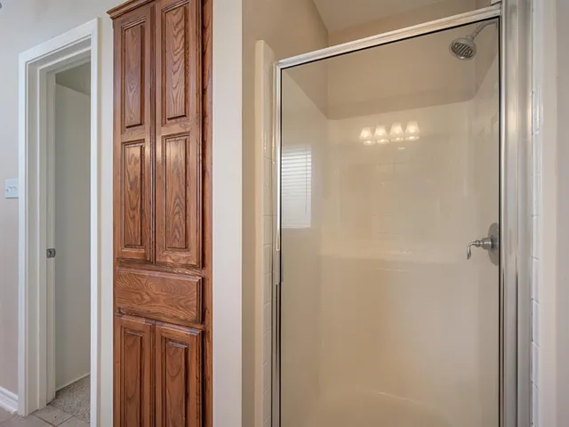 a bathroom with a glass shower door