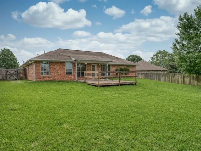 a view of a house with a backyard porch and sitting area