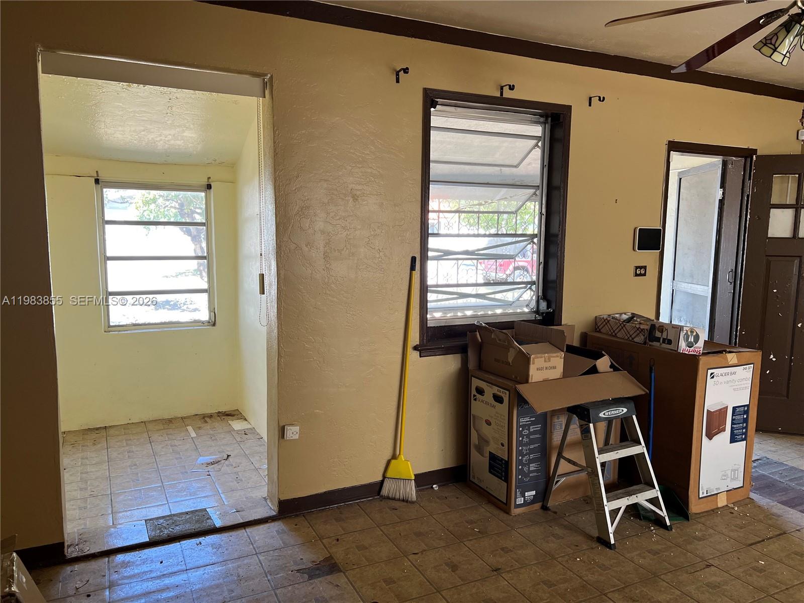 4420 Southwest 3rd Street Miami, FL 33134 - Photo 6 of 44 a view of a workspace with furniture and a window