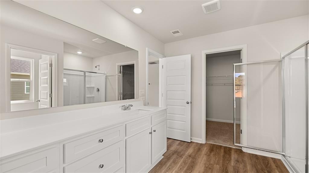 906 Stow Lane Monroe, GA 30655 - Photo 22 of 28 a spacious bathroom with a shower sink and mirror