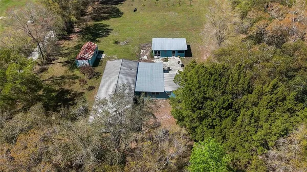 an aerial view of a house with a yard