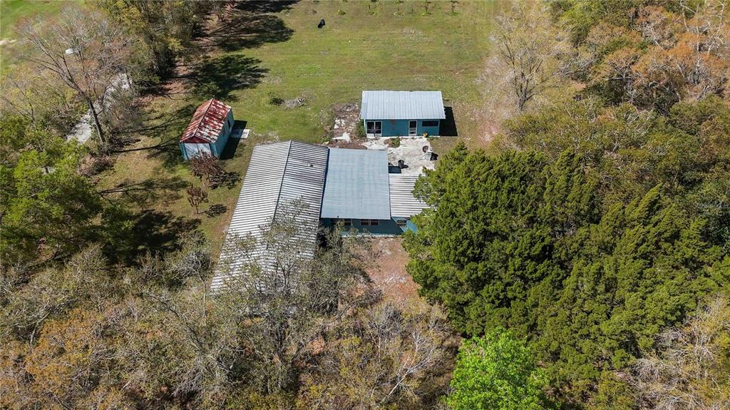 an aerial view of a house with a yard