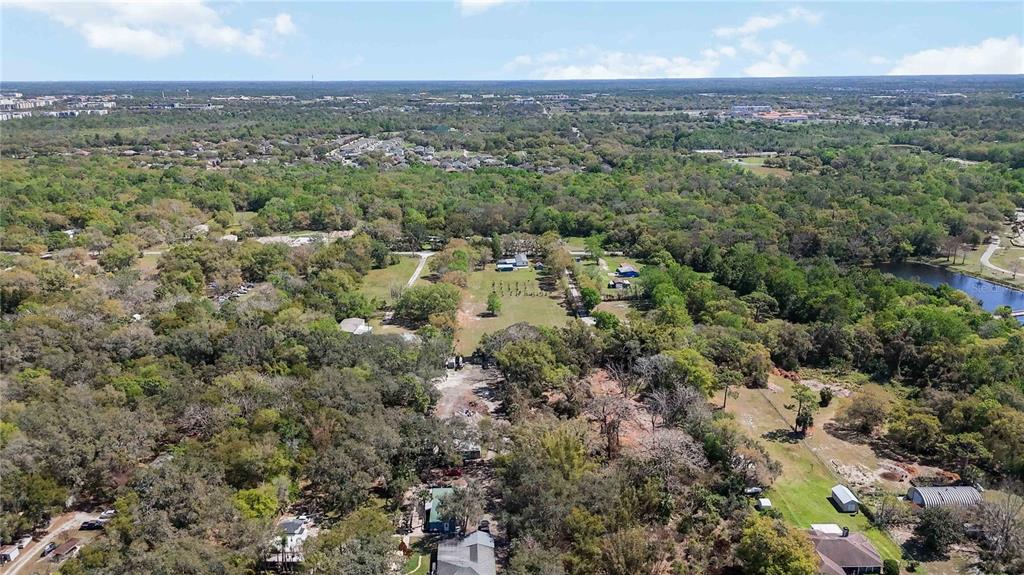 2700 Aein Road Orlando, FL 32817 - Photo 7 of 14 an aerial view of residential houses with outdoor space and trees