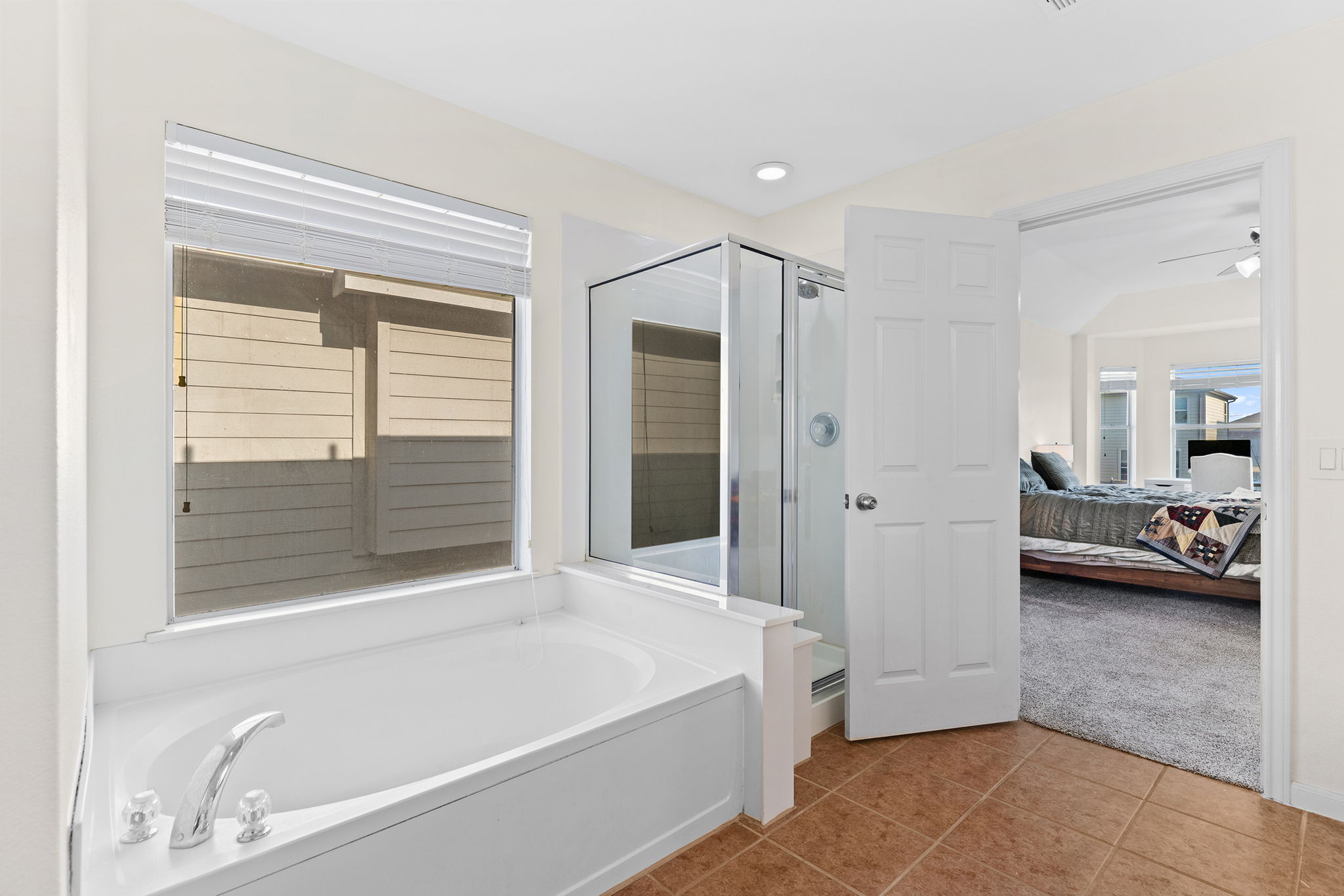 3517 Shiraz Loop Round Rock, TX 78665 - Photo 19 of 40 Soaking tub with deck-mounted chrome fixtures, glass-enclosed shower, tile flooring, and a window with blinds
